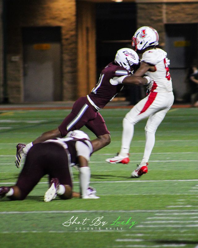 A receiver taken down mid play, both of them still off the ground