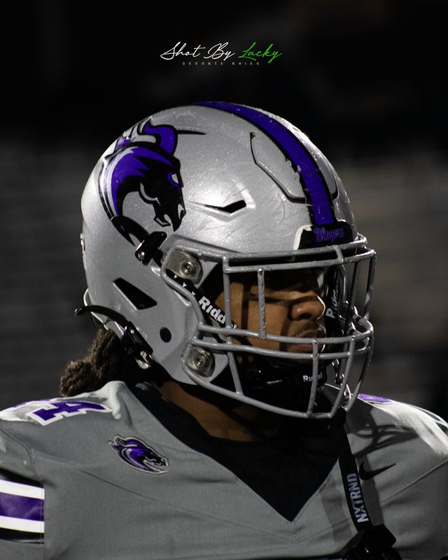Close on a helmet, the player looking off down the field