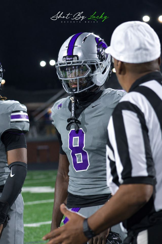 A player listening to the referee between plays