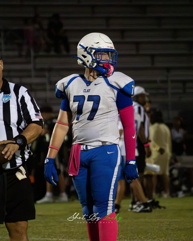 A lineman on the sideline beside the officials