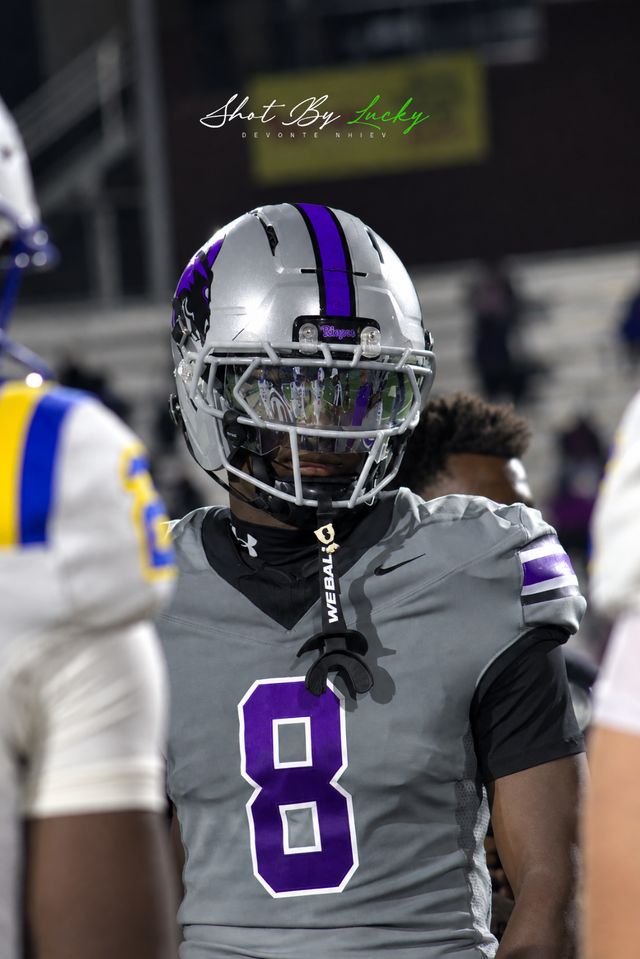 A receiver in grey waiting for the ball to come his way