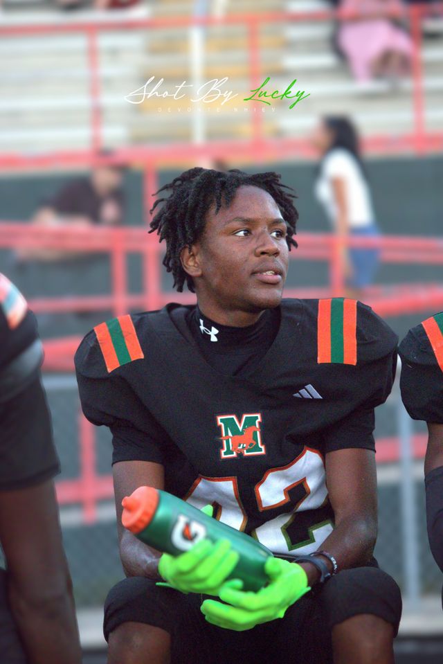 A player taking a drink on the sideline